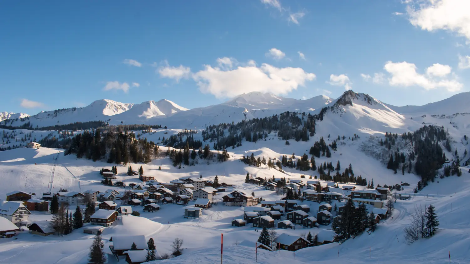 The snow-covered mountain village of Stoos in front of the surrounding peaks